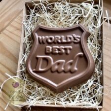 A large gift boxed chocolate shield saying “World’s Best Dad”